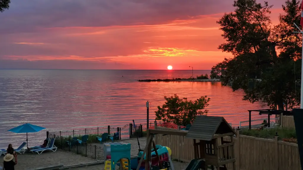 Dramatic orange and red sunset over the water, a beautiful backdrop for a CARI event.