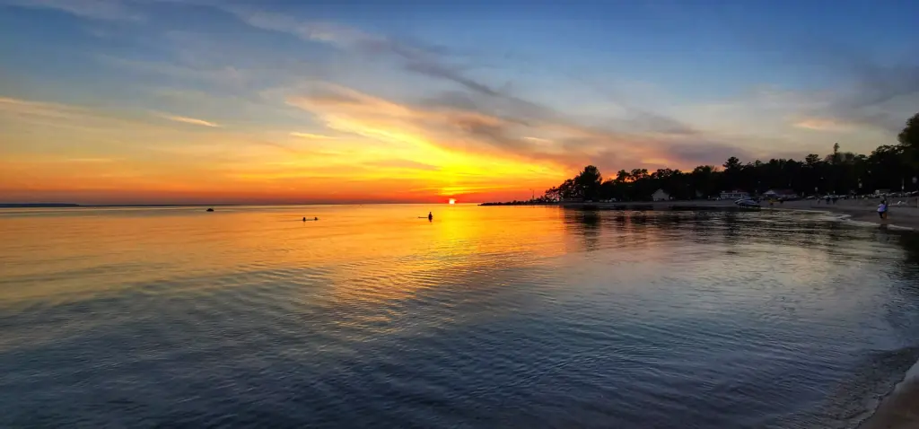 Golden hour view of the sunset on the beach with guests enjoying the CARI destination.