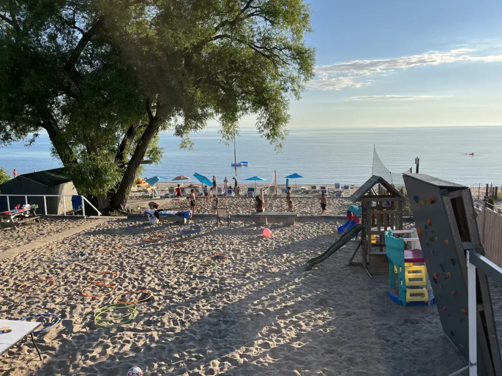Guests walking along a sunny resort boardwalk or path, part of the CARI experience.