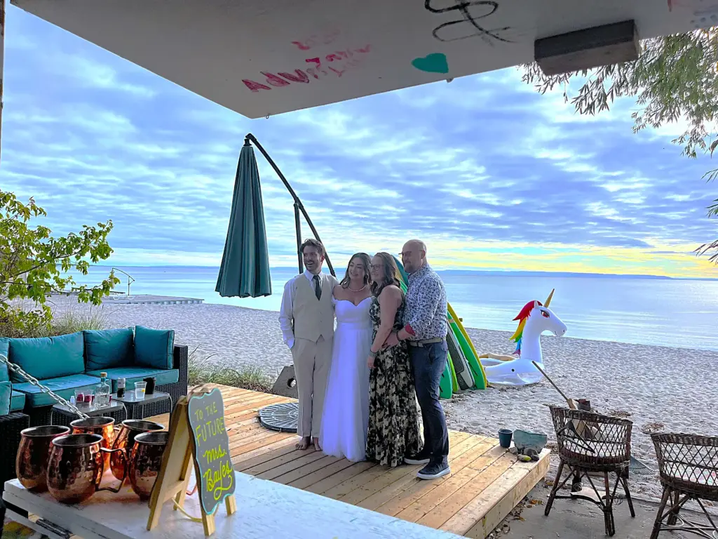 Guests enjoying a CARI beachfront event or wedding reception under a covered patio.