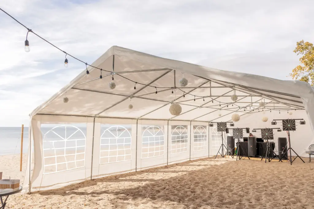 Beachfront event tent setup with lighting and sound system at CARI private waterfront resort for weddings, celebrations, and retreats