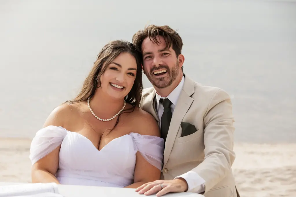 CARI destination wedding moment: Smiling bride and groom close-up portrait on the beach.
