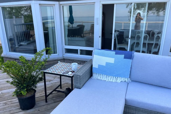 Outdoor patio lounge with seating at CARI waterfront resort overlooking the lake