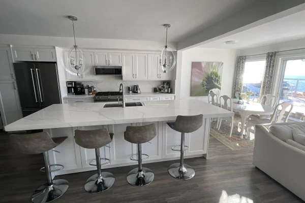 Bright open-concept kitchen with island seating at CARI private waterfront resort accommodations
