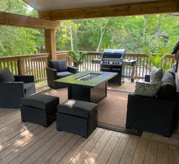 Covered outdoor deck with lounge seating at CARI private waterfront resort