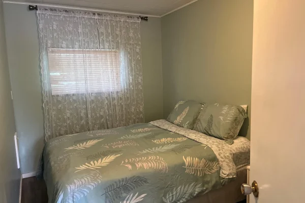 Comfortable bedroom with natural light in CARI private waterfront resort accommodations