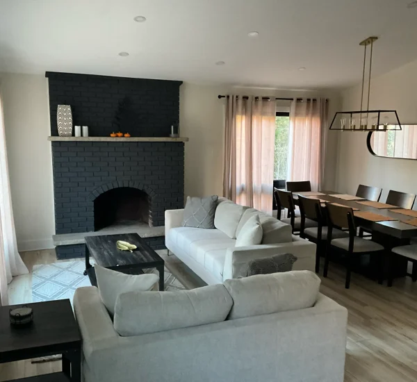 Open living and dining area with fireplace at CARI private waterfront resort accommodations